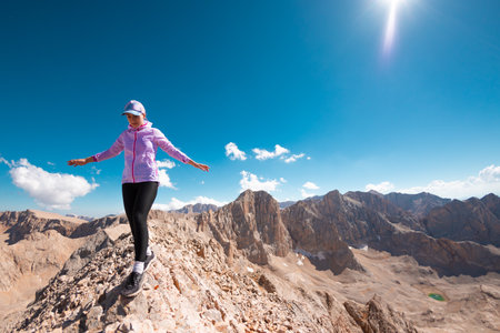 hiking in the mountains. Girl with a backpack in the mountainsの写真素材