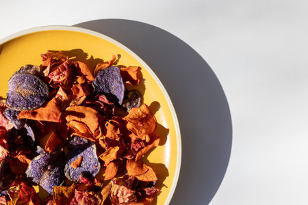 Close-up of orange and red carrot and beet chips on a plate. Organic vegetable chips.の写真素材