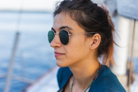 Portrait of a girl in sunglasses sitting on a yacht. vacation and travel conceptの写真素材
