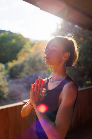 The girl is doing yoga. Young athletic woman trainer practicing yoga instructor individual training. pose, modern gym, balancing healthy lifestyle concept. sports in nature.の写真素材