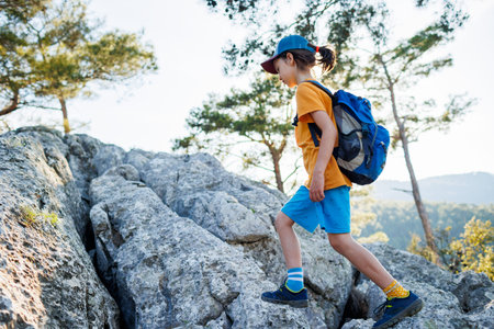 Adventure and travel. a little boy with a backpack walks along a forest path. trips with children....