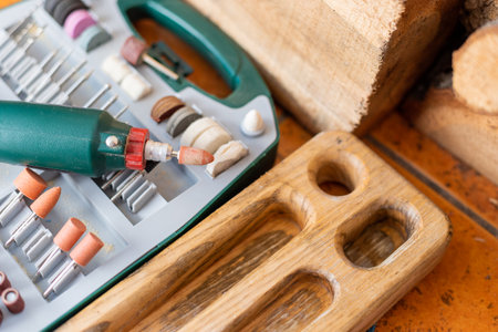 box with accessories for processing and engraving next to an electric tool. hobby and creativity.の写真素材