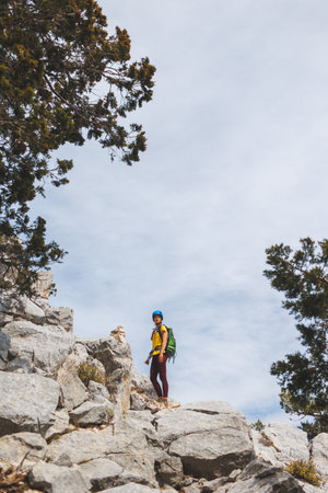 Amazing landscape with a mountain range and a tourist with a backpack in the foreground. mountaineering and climbing. adventure in the mountains.の写真素材