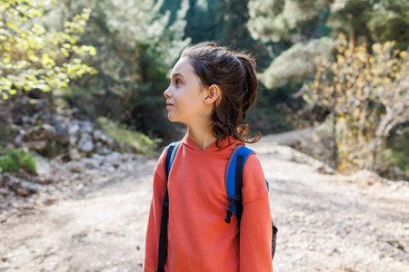 portrait of a child with a backpack outside the city. a boy with a backpack. adventure and hiking.の写真素材