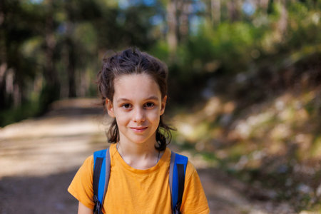 portrait of a child with a backpack outside the city. a boy with a backpack. adventure and hiking.
