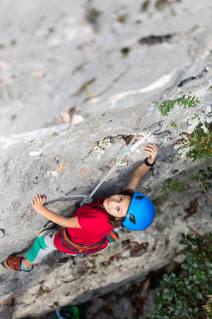 climber boy. the child trains in rock climbing. sports in nature.の写真素材