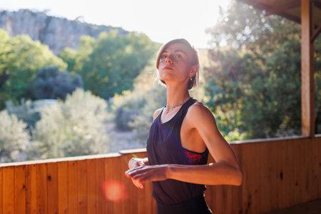 The girl is doing yoga. Young athletic woman trainer practicing yoga instructor individual training. pose, modern gym, balancing healthy lifestyle concept. sports in nature.の写真素材