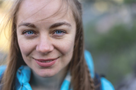Smiling, positive blonde with tousled hair. portrait of a girl with facial hair. Travel and hiking...