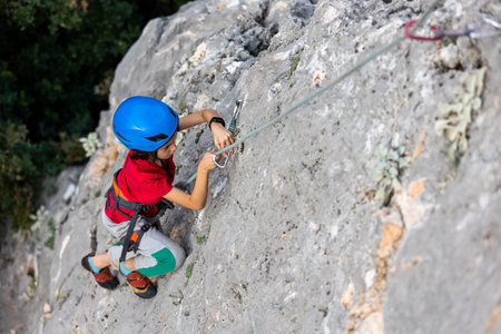climber boy. the child trains in rock climbing. sports in nature.の写真素材