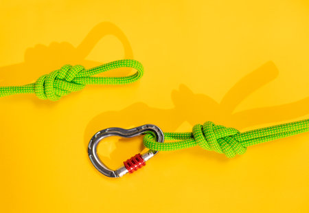 Carabiner and knot from a climbing rope. Equipment for climbing and mountaineering. Knot eight. safety rope.の写真素材