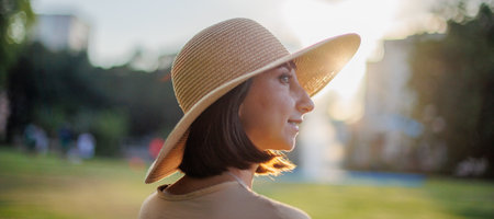 beautiful portrait. beautiful girl in a hat. Close-up portrait of a beautiful smiling girl with brown hair in a hat while walking on the street.の写真素材