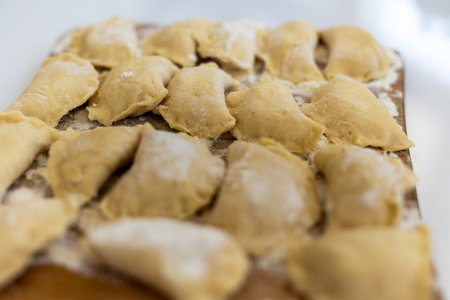 Raw dumpling with potatoes. Preparation dumplings on a wooden board.の写真素材