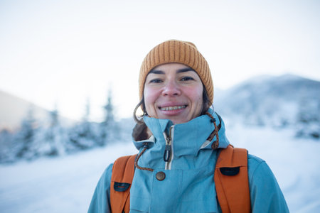 A woman walks in snowshoes in the snow, winter trekking, a person in the mountains in winter, hiking equipmentの写真素材