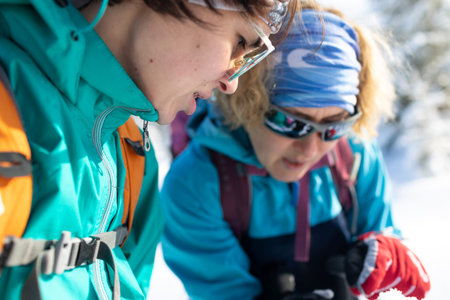 Portrait of two attractive young female hikers outdoors in winter during a winter hike. two tourists...
