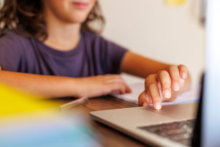 child at school. the child uses a laptop for learning. training using modern technologies. boy in...