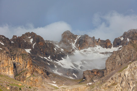 Passing clouds over a landscape in Turkey with snow capped mountains in the background. Landscape of mountain range and mountains. mountaineering in Turkey. Dedegol. Turkey.の写真素材