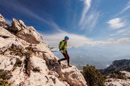 A girl with a backpack on a hike. adventure in the mountains. hiking with a backpack. girl with a backpack in the high mountains. Rock climbing and mountaineering concept. Turkey.の写真素材