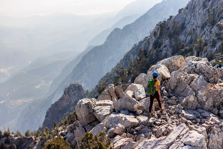 A girl with a backpack on a hike. adventure in the mountains. hiking with a backpack. girl with a backpack in the high mountains. Rock climbing and mountaineering concept. Turkey.の写真素材