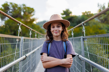 portrait of a confident child. a boy in a hat stands on the street. adventure and travel.の写真素材