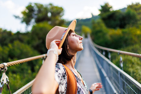 happy girl travels. young woman in a hat and with a backpack enjoys traveling. Travel and adventure.の写真素材