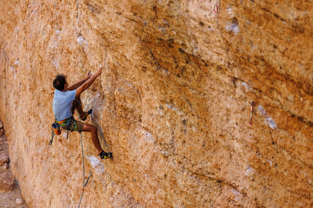 climber climbs the wall. a man is engaged in sport climbing. sport and active lifestyle.