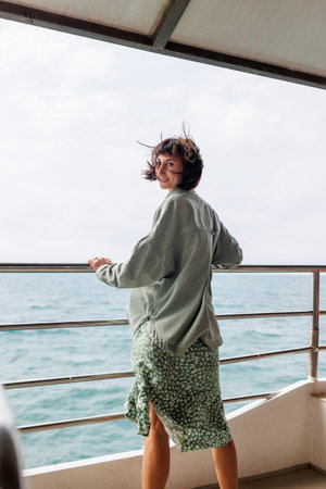 Woman on vacation on a cruise ship during summer travel. Silhouette of a tourist relaxing on the...