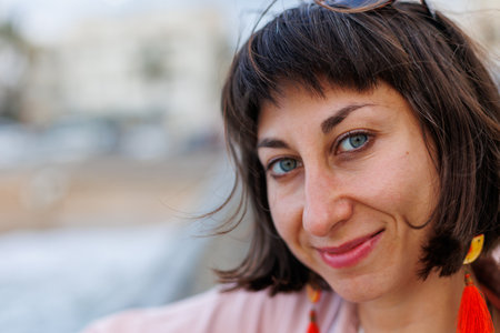 close-up portrait of a pretty young woman smiling. Portrait of a young smiling woman looking happy.の写真素材