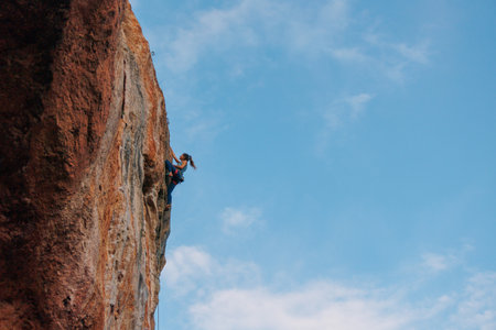 rock climber girl. rock climber girl climbs an overhanging rock. sports and outdoor recreationの写真素材