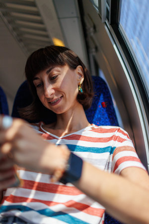 Public transport. Woman on the train. young woman with smartphone while traveling by train. Enjoying...
