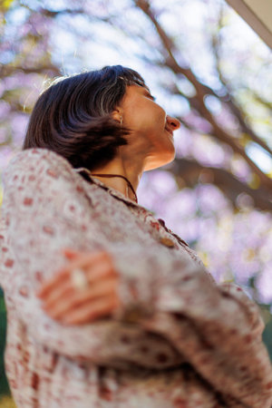 Portrait of a young beautiful smiling woman in a fashionable summer dress. Carefree woman posing on the street. Positive model having fun on a walk. Cheerful and happy.の写真素材