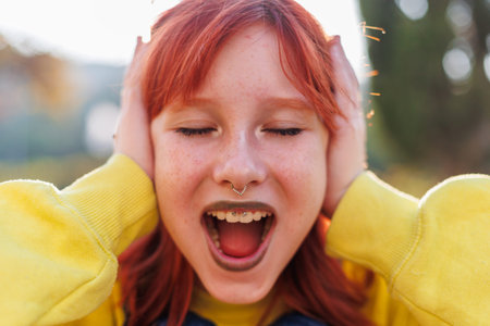 Upset girl screaming, teenager with facial piercing. shock and emotional breakdown, depression.