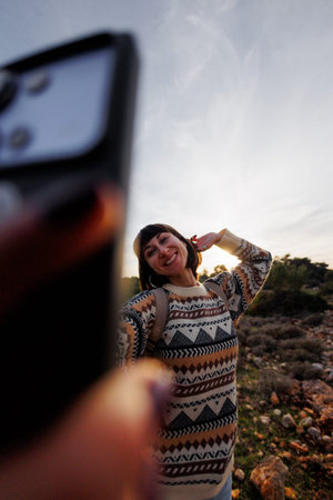 girl takes selfie photo on top of mountain, autumn hike with backpacks. girl travels. selfie photo.