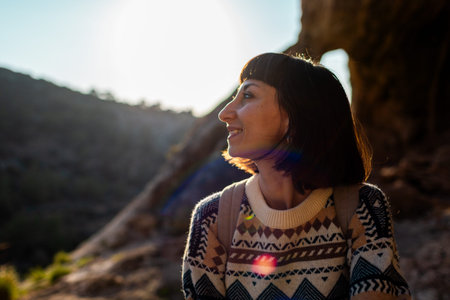 Girl with backpack. Portrait of happy female tourist in mountains. Trekking and hiking. Sports and...