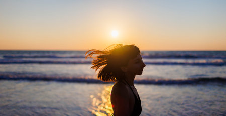 Young happy girl smiling. Wind in your hair. hair covers the face. Close up portrait of a beautiful...