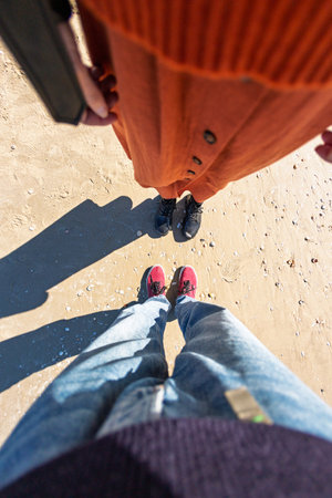 girl and boy holding hands. walk on the beach. travel and vacationの写真素材