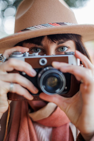 young woman with a film camera. Hipster tourist woman with camera. the girl takes photographs with a film camera. lifestyle concept. film camera Fashionable look.の写真素材