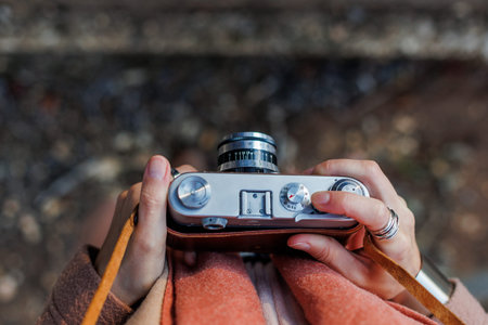 young woman with a film camera. Hipster tourist woman with camera. the girl takes photographs with a...