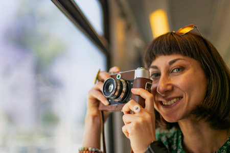 train travel. train passenger A young beautiful girl with a camera enjoys a train ride. Enjoy your...