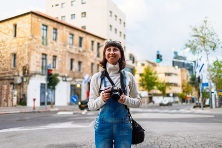 Woman photographer with dslr camera taking pictures outdoors. Girl with camera outdoors. Home hobby, lifestyle. travel and vacation.の写真素材