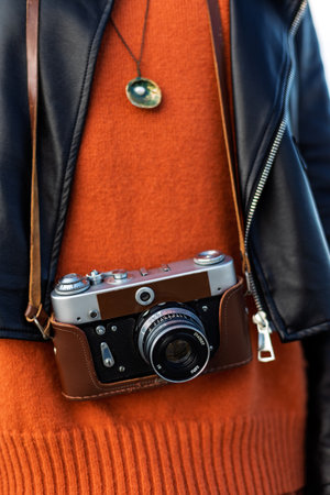 photographer adjusts camera. girl travels and takes pictures of sights. stylish girl with film camera. adventures and travels.の写真素材