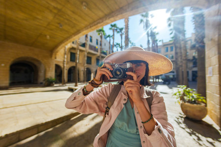 Woman photographer with camera taking pictures outdoors. Girl in dress with camera outdoors....