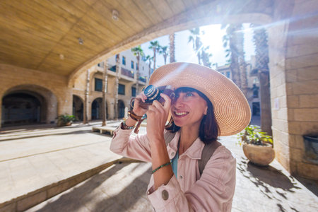 Woman photographer with camera taking pictures outdoors. Girl in dress with camera outdoors....