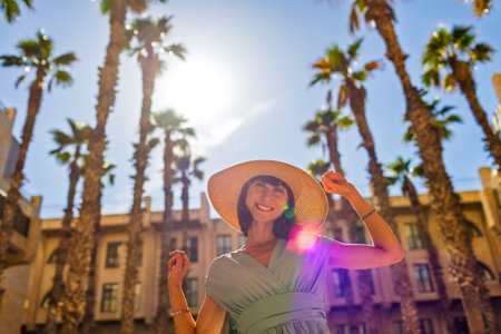 A stunning young woman with amazing looks walks along a beautiful street in the old city of Jaffa. Israel. Travel and adventure.の写真素材