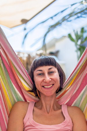 Girl lying in hammock. Happy young woman enjoying summer vacation. Romantic carefree mood concept. Summer mood.の写真素材