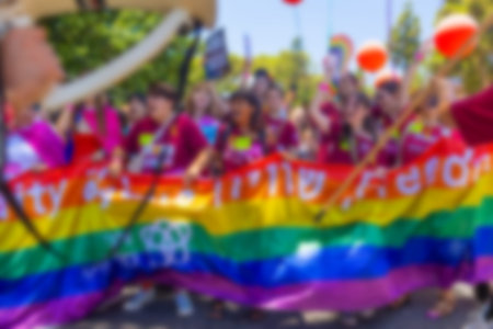A blurry photo of LGBT parade participants. The movement, the LGBT community. Abstract, blurry, bokeh background, image for the background.の写真素材