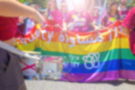A blurry photo of LGBT parade participants. The movement, the LGBT community. Abstract, blurry, bokeh background, image for the background.の写真素材