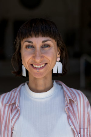 Happy woman portrait and piercing in lower lip, confidence or cheerful attitude in city. Woman,...