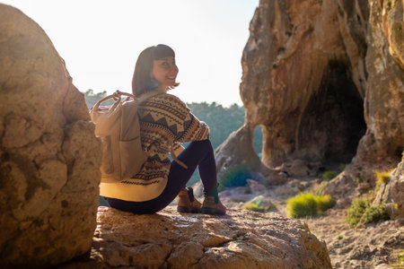 Portrait of happy female tourist in mountains. girl smiles. trekking and hiking. Concept of sport and healthy lifestyle. girl with backpack.の写真素材