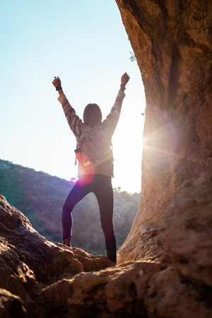 happy woman in mountains. girl traveling in the mountains. trekking and hiking. concept of sport and healthy lifestyle. girl with backpack.の写真素材