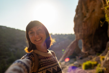 follow me. happy couple traveling. portrait of happy female tourist in mountains. girl smiling. trekking and hiking. sport and healthy lifestyle concept. girl with backpack.の写真素材